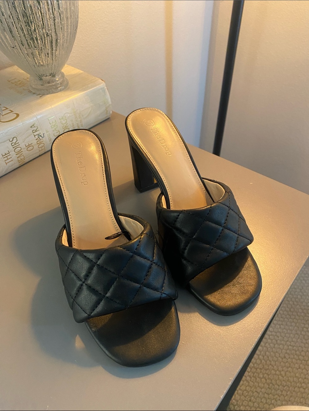 The Drop Quilted Black Block Heel Mules for Women w/gold accent.